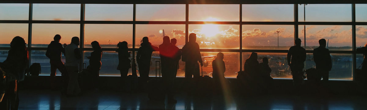 People at airport Photo by Jon Tyson on Unsplash